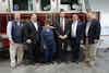 a group of people standing in front of a fire truck