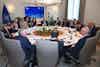 a group of people around a round table
