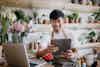 a man in an apron holding a tablet